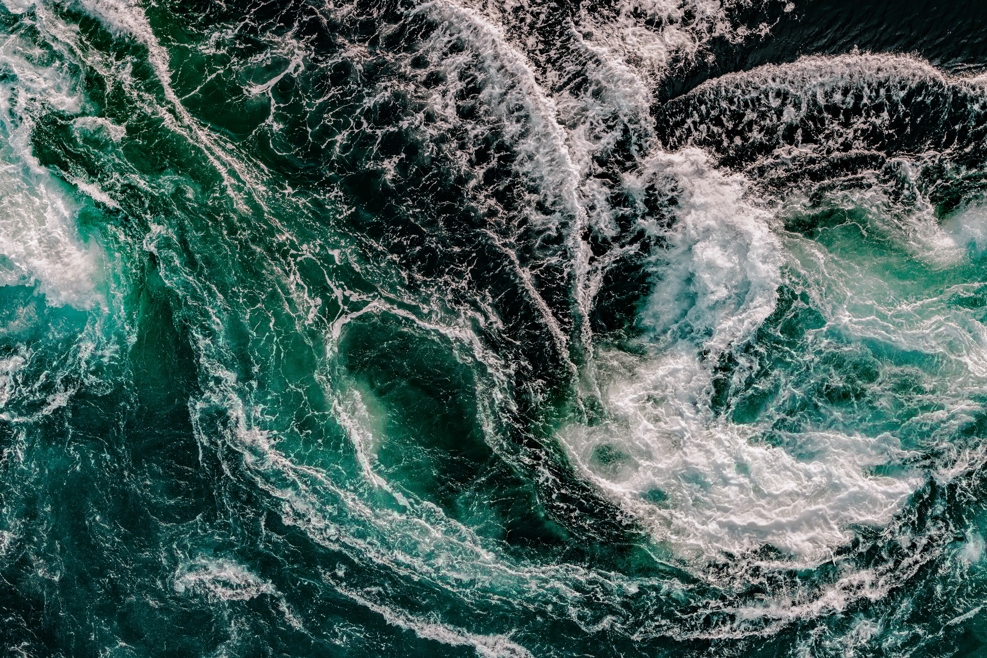 Blue waves of water of the river and the sea meet each other during high tide and low tide.